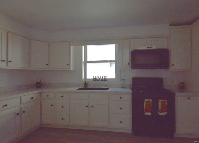 kitchen featuring white cabinetry and sink