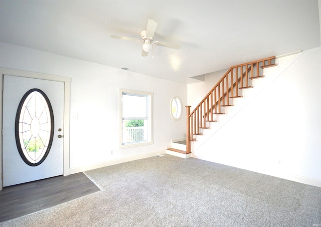 carpeted foyer with ceiling fan