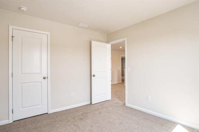 unfurnished bedroom with light carpet