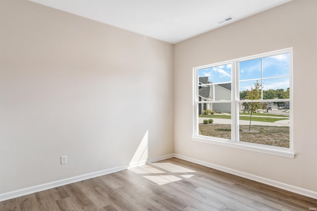 unfurnished room with light hardwood / wood-style flooring and a healthy amount of sunlight