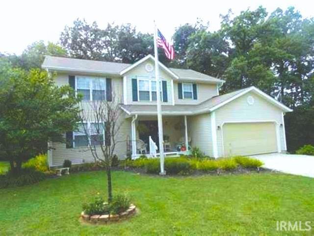 view of front of property featuring a front yard and a garage