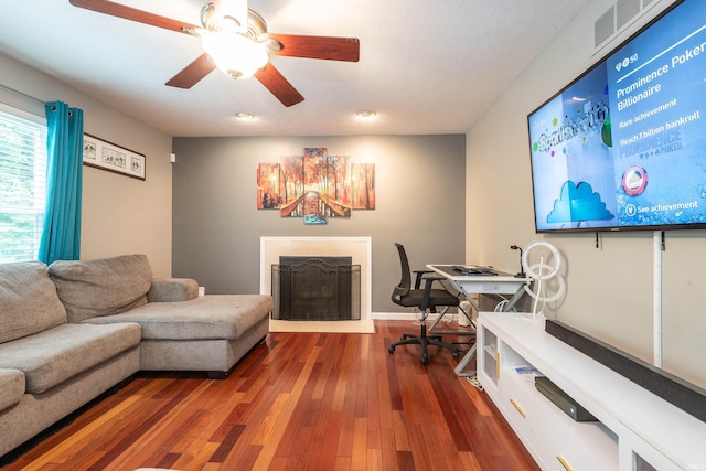 home office with dark hardwood / wood-style floors and ceiling fan