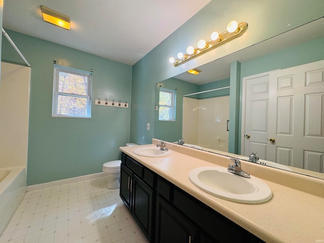 full bathroom with vanity, toilet,  shower combination, and plenty of natural light