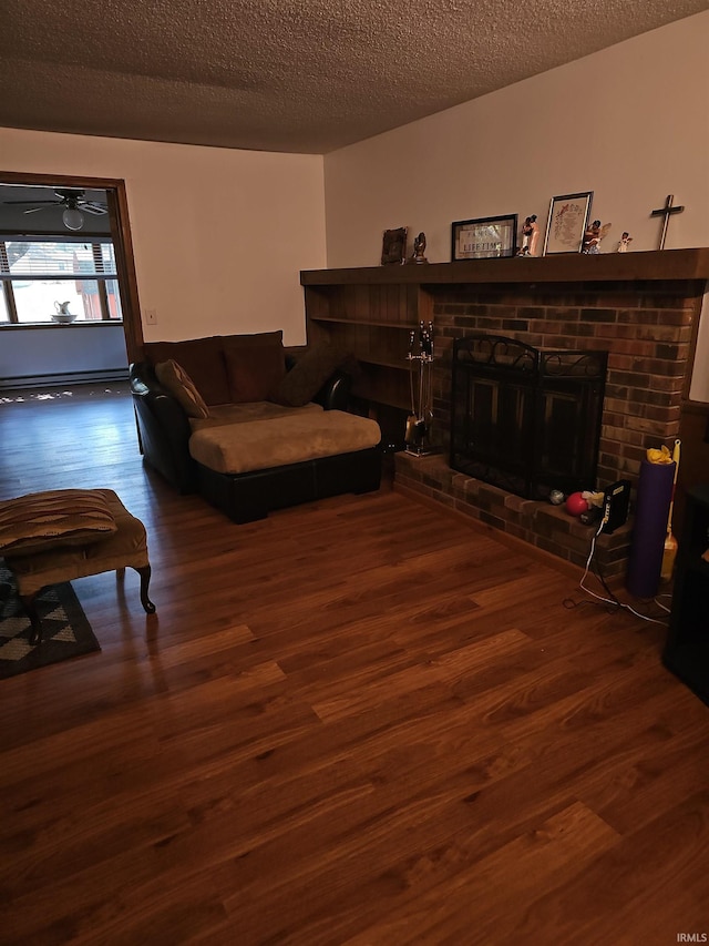 living room with a fireplace, dark hardwood / wood-style flooring, and a textured ceiling