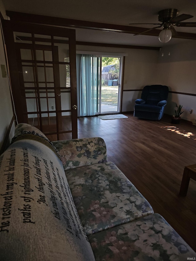 living room featuring hardwood / wood-style floors and ceiling fan