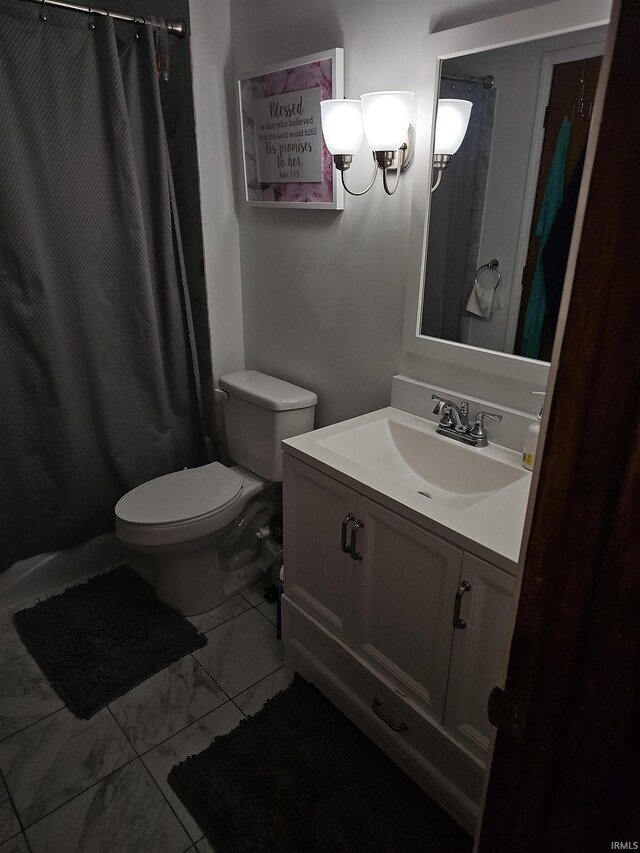 bathroom featuring vanity, toilet, and a shower with shower curtain