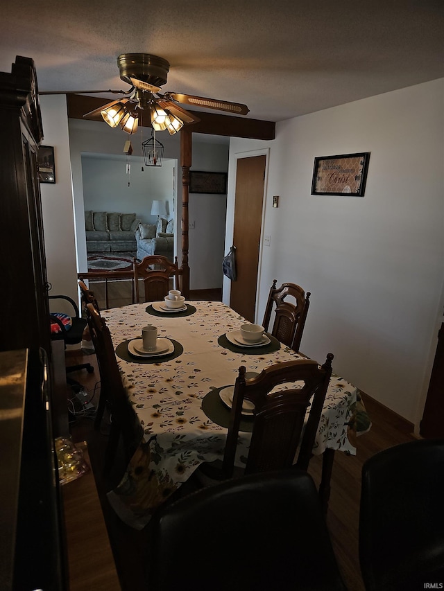 dining space featuring ceiling fan, dark hardwood / wood-style floors, and a textured ceiling