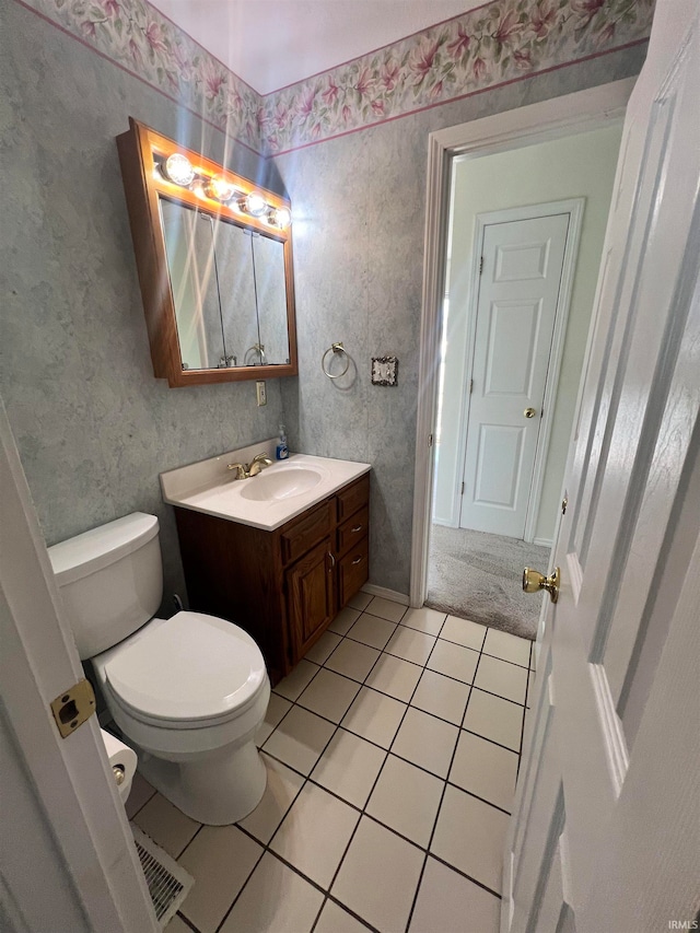 bathroom with vanity, toilet, and tile patterned floors