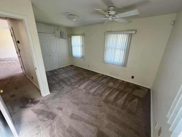 unfurnished bedroom featuring ceiling fan, a closet, and carpet floors