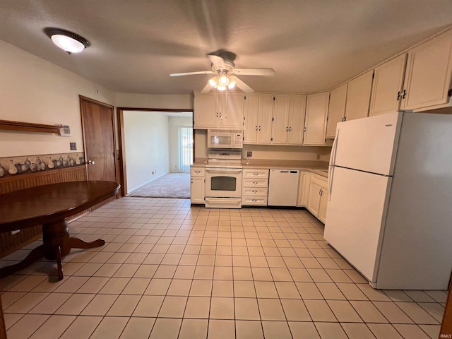 kitchen with ceiling fan, light tile patterned floors, white appliances, and white cabinetry