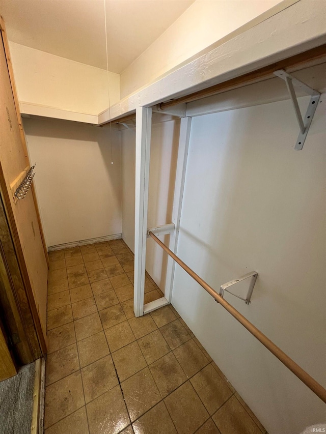 spacious closet with tile patterned floors