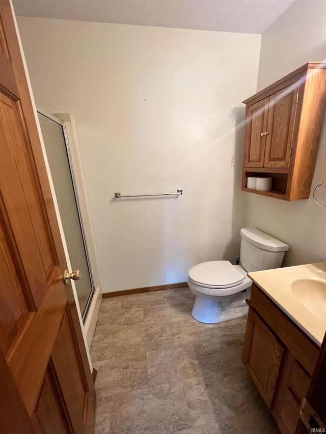 bathroom featuring a textured ceiling, vanity, toilet, and an enclosed shower