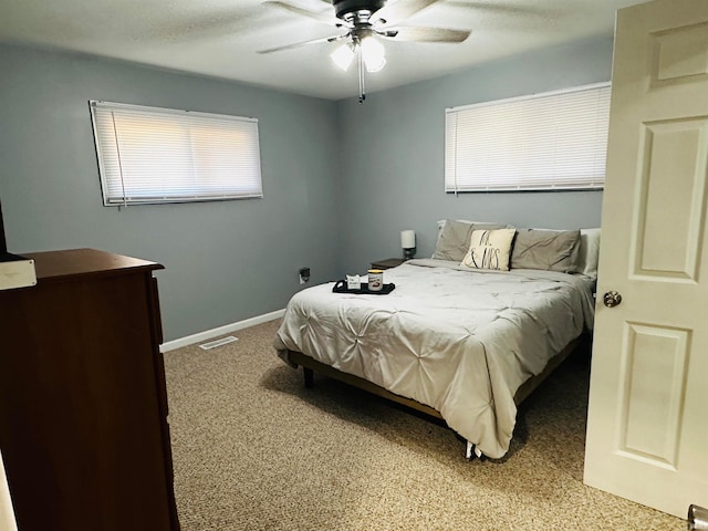 bedroom featuring ceiling fan and carpet