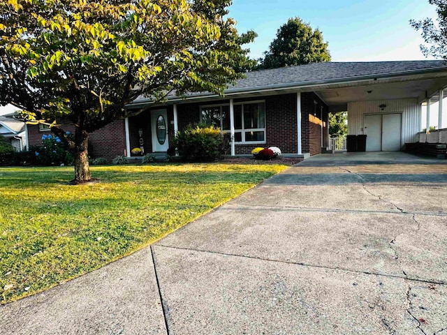 ranch-style home with a garage, a carport, and a front lawn