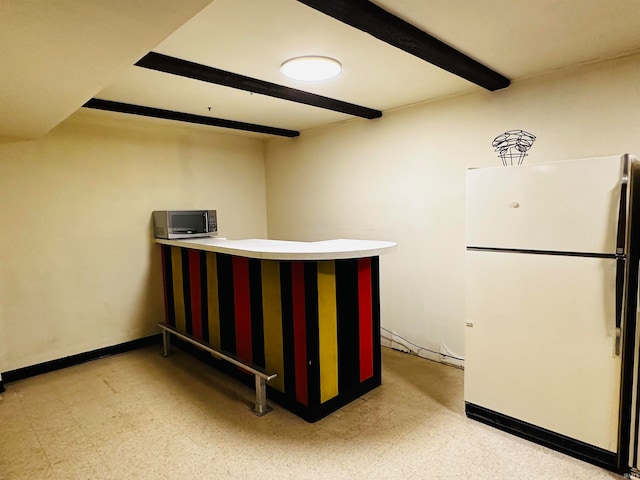 interior space with beamed ceiling and white refrigerator