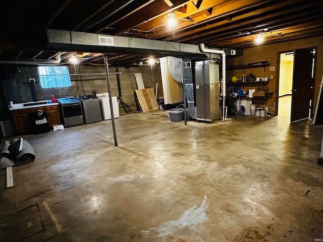 basement featuring heating unit and washing machine and clothes dryer