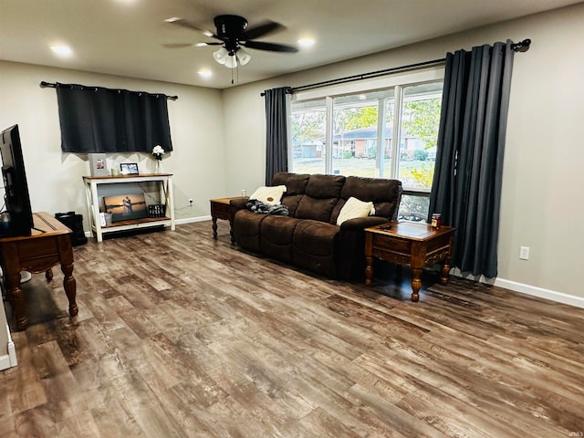 living room with wood-type flooring and ceiling fan