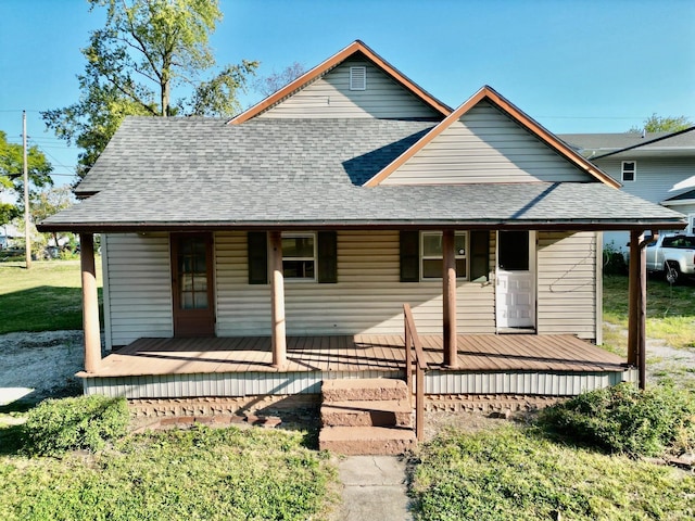 view of front of home featuring covered porch and a front lawn