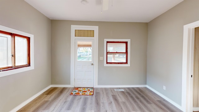 entryway with ceiling fan and light hardwood / wood-style flooring