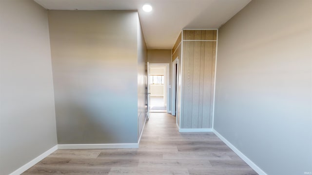 corridor with light hardwood / wood-style floors