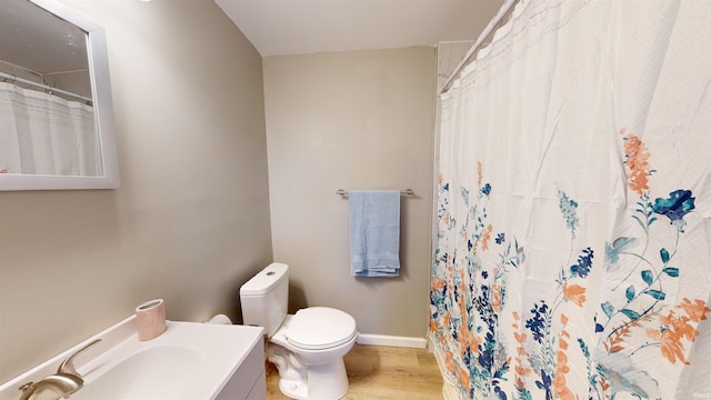 bathroom featuring vanity, toilet, a shower with curtain, and hardwood / wood-style floors