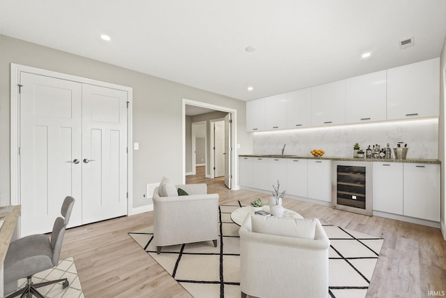 living room featuring light hardwood / wood-style flooring and wine cooler