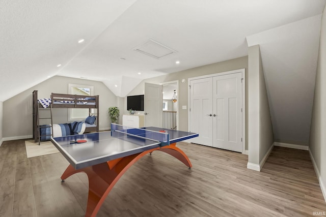 game room featuring light wood-type flooring and lofted ceiling