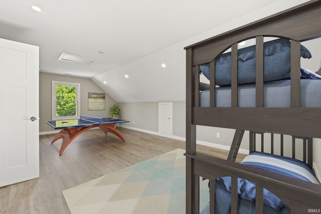 bedroom featuring light wood-type flooring and lofted ceiling