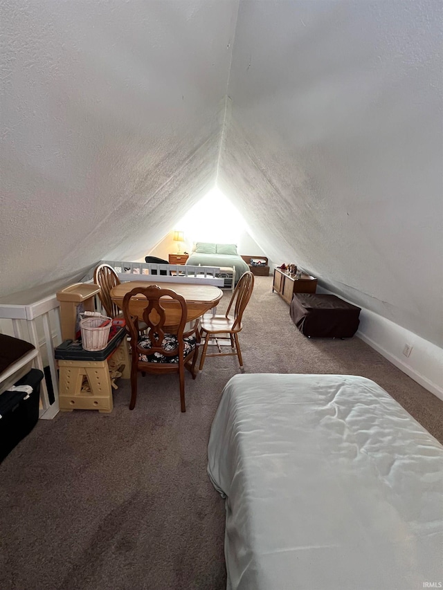 bedroom with lofted ceiling, a textured ceiling, and carpet floors