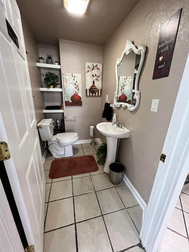 bathroom featuring toilet and tile patterned floors