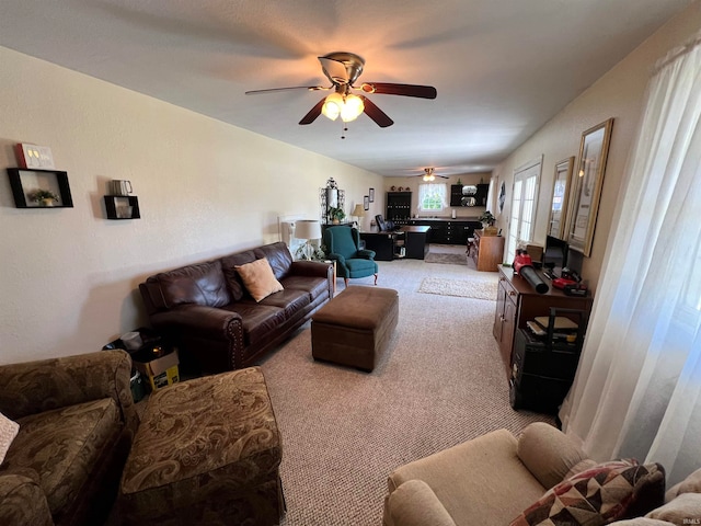 living room featuring ceiling fan and light colored carpet