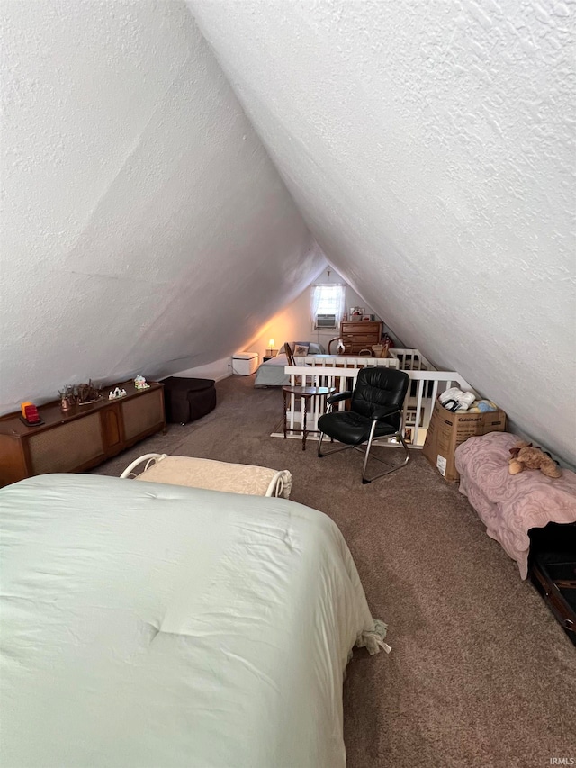 bedroom with lofted ceiling, a textured ceiling, and carpet flooring