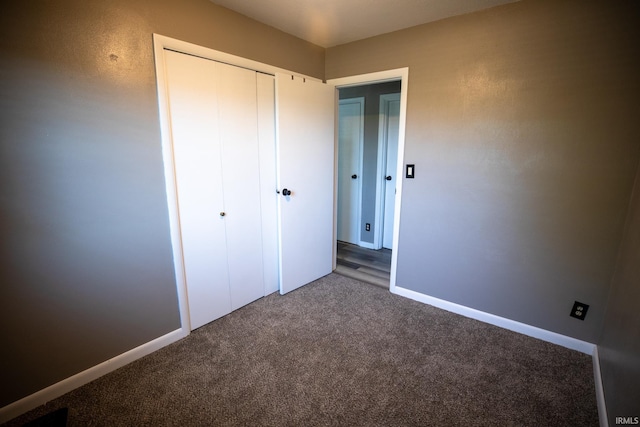 unfurnished bedroom with a closet and carpet floors