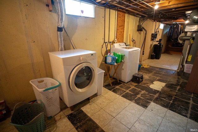 laundry room featuring tile patterned floors and washing machine and dryer