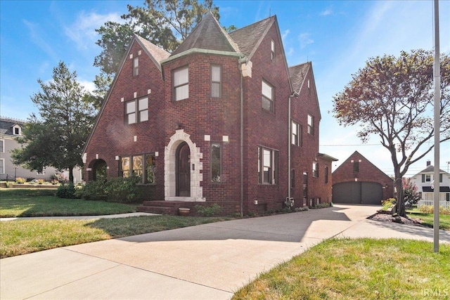 view of front of home with a garage and a front lawn