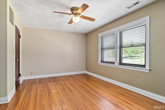 unfurnished room with ceiling fan and hardwood / wood-style flooring