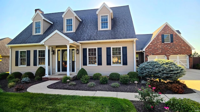 cape cod house featuring a garage