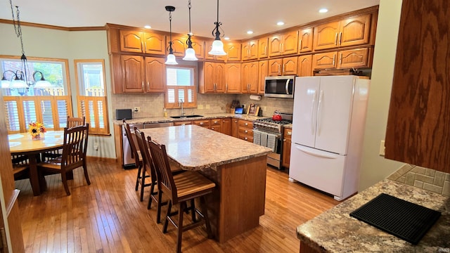 1509 Hawksview Dr, Marion, IN 46952 - kitchen featuring a sink, tasteful backsplash, brown cabinetry, and appliances with stainless steel finishes