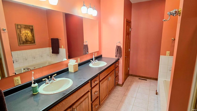 bathroom with vanity, tile patterned flooring, and a tub