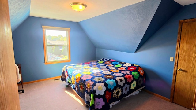 carpeted bedroom featuring vaulted ceiling