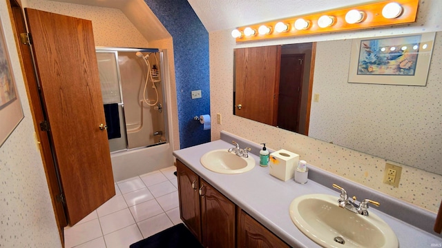 bathroom featuring tile patterned flooring, a textured ceiling, shower / bath combination with glass door, and vanity