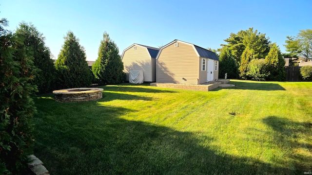 view of yard with an outbuilding and an outdoor fire pit