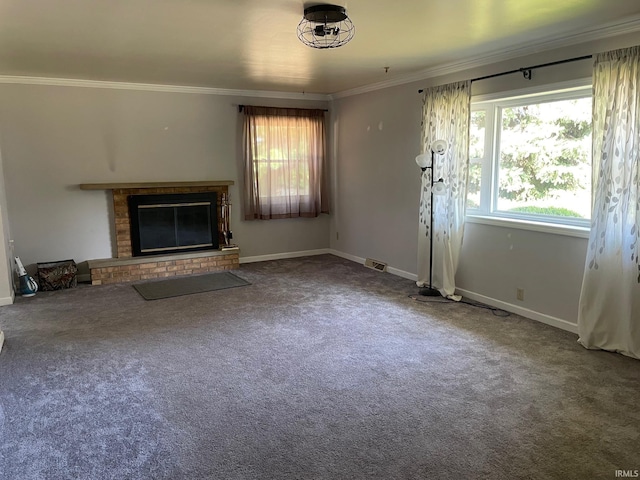 unfurnished living room with a brick fireplace, carpet floors, and ornamental molding