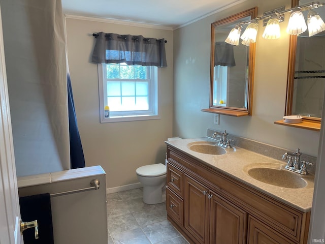 bathroom featuring ornamental molding, vanity, and toilet