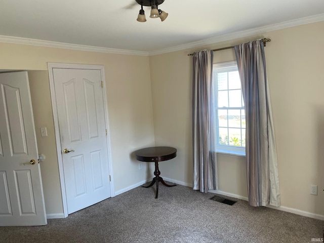 carpeted spare room featuring ornamental molding