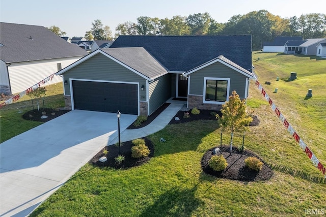 view of front of home with a front yard and a garage