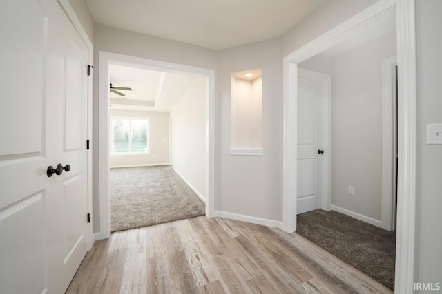 corridor featuring light colored carpet