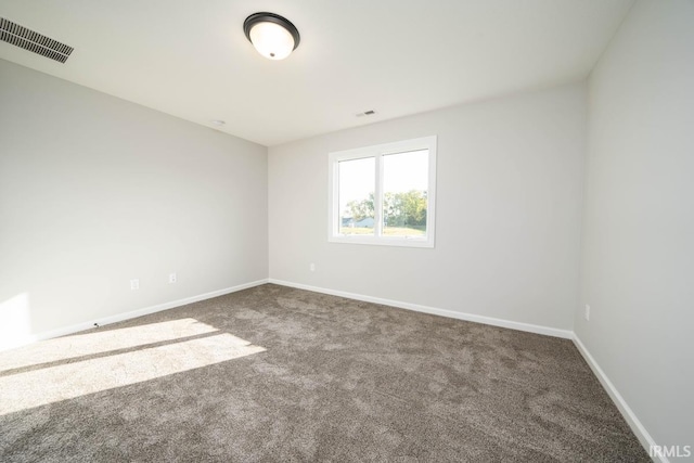 unfurnished room featuring carpet