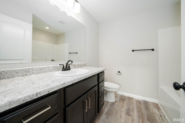 full bathroom featuring separate shower and tub, hardwood / wood-style flooring, vanity, and toilet