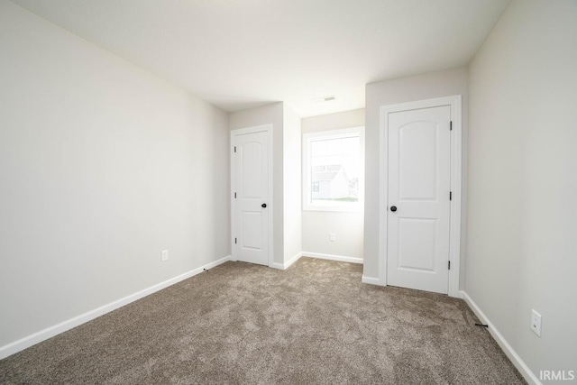 unfurnished bedroom featuring light colored carpet